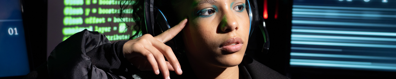 Female employee at work, surrounded by computer screens