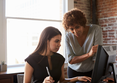 A mentor helping an apprentice.